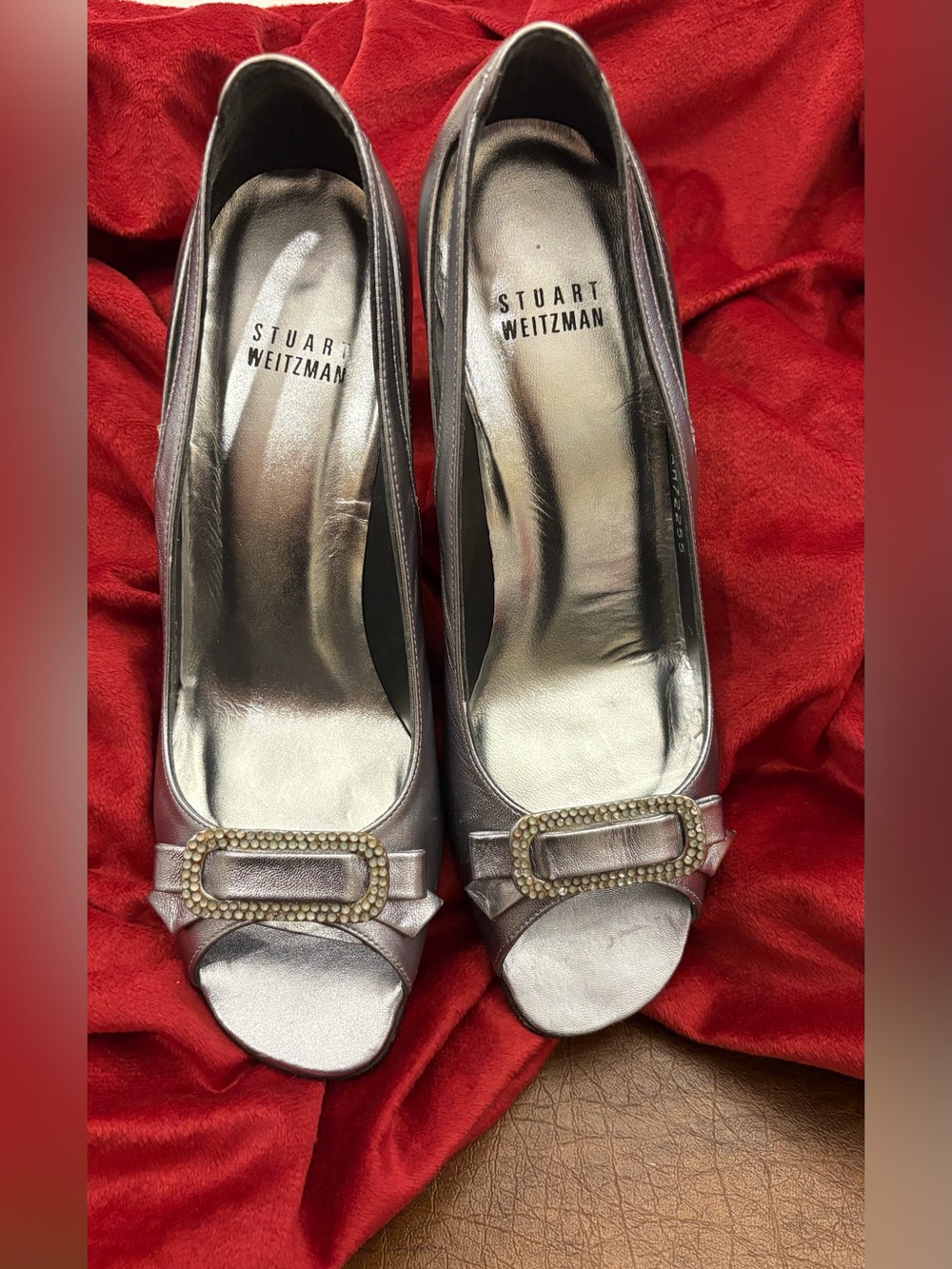 Stuart Weitzman Metallic Silver Peep-Toe Pumps with Jeweled Buckle. Size 7B